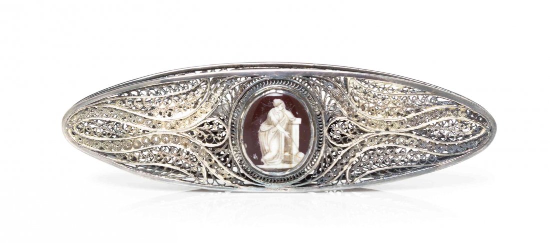 A Silver Filigree and Enamel Tatting Shuttle, Width 3: A Silver Filigree and Enamel Tatting Shuttle, PROBABLY ENGLISH, 19TH CENTURY, with foliate scrollwork throughout and enameled plaques depicting classical figures, apparently unmarked. Width 3 1/2 inch