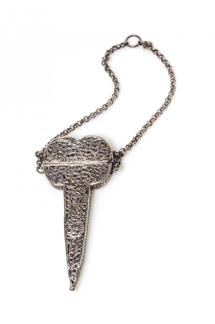 A Silver Filigree Scissor Case, Height 2 7/8 inches.: A Silver Filigree Scissor Case, PROBABLY ENGLISH, LATE 17TH CENTURY, the cover and body formed of filigree scrolls and linked by chains attached to a suspension ring, marks on flange obscured. Height 