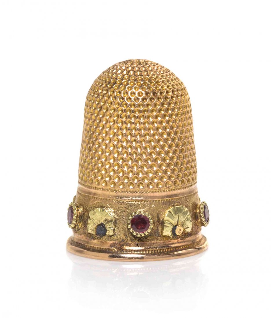 A French Vari-Color Gold Thimble, Height 7/8 inch.: A French Vari-Color Gold Thimble, PROBABLY MICHAEL VEYDER, PARIS, CIRCA 1826, the lower body with a band of green gold foliage alternating with cabochon rubies on a matted ground, all below an applied