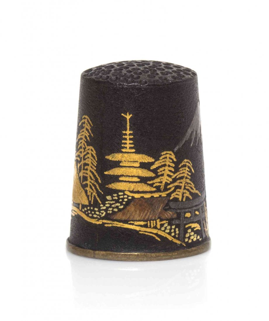 A Japanese Mixed Metals Thimble, Height 7/8 inch.: A Japanese Mixed Metals Thimble, with indentations at the top, the body depicting a continuous landscape. Height 7/8 inch.