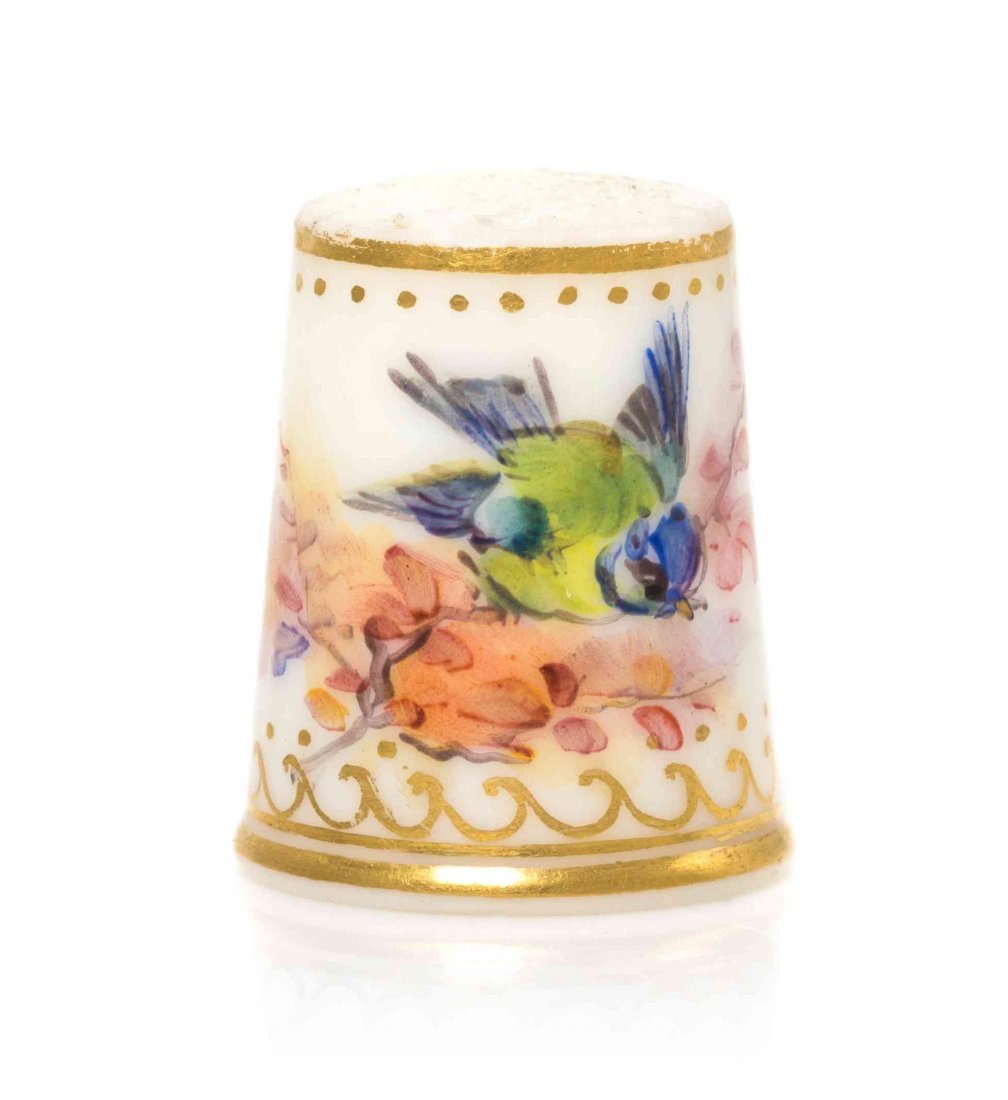 An English Porcelain Thimble, Height 15/16 inch.: An English Porcelain Thimble, 19TH CENTURY, painted to show a blue and green bird perched on a leafy branch, with gilt highlights. Height 15/16 inch. Provenance: D&M Manheim, New York, NY