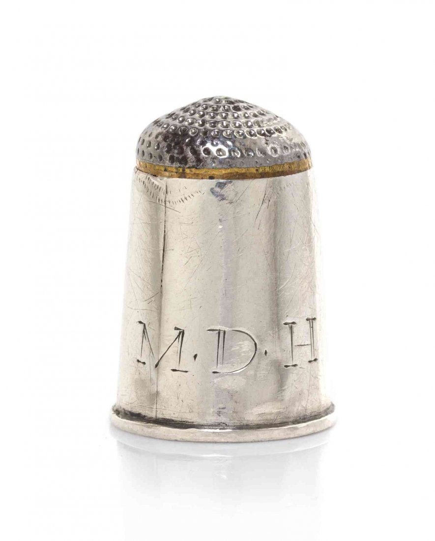 An American Silver Thimble, Height 3/4 inch.: An American Silver Thimble, CIRCA 1825-50, with a steel top, the plain sides engraved with block initials MDH, apparently unmarked. Height 3/4 inch.