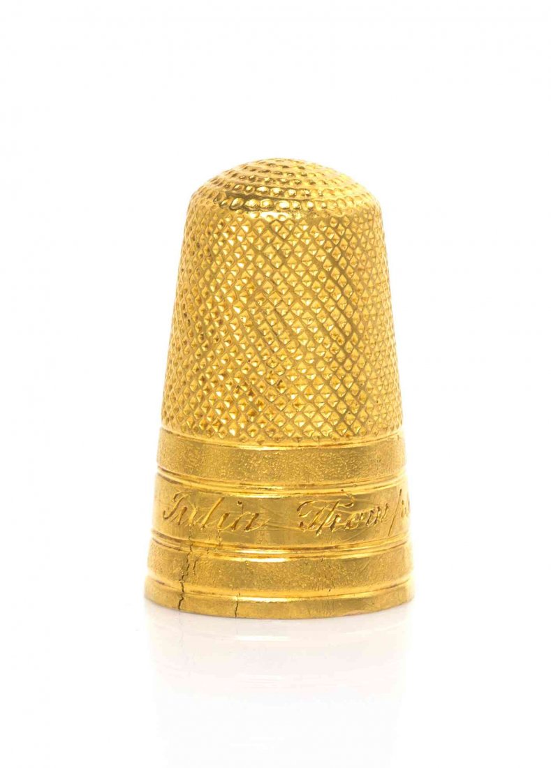 A Gold Thimble, Height 7/8 inch.: A Gold Thimble, POSSIBLY AMERICAN, 19TH CENTURY, the lower body engraved "Julia Thompson" between two matted bands, apparently unmarked. Height 7/8 inch.