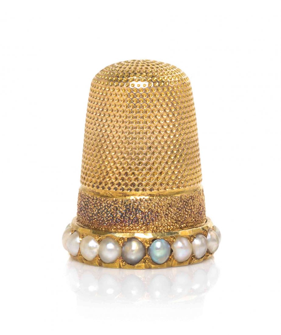 A Pearl Mounted Gold Thimble, Height 7/8 inch.: A Pearl Mounted Gold Thimble, PROBABLY AMERICAN, LATE 19TH / EARLY 20TH CENTURY, the lower body with a matted band and rim mounted with pearls, apparently unmarked. Height 7/8 inch.