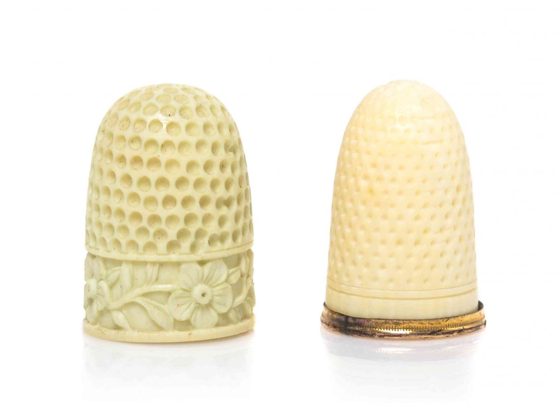 Two Ivory Thimbles, Height of first 7/8 inch.: Two Ivory Thimbles, 19TH CENTURY, comprising an English example carved to show a floral band and a French example with a gilt rim. Height of first 7/8 inch.