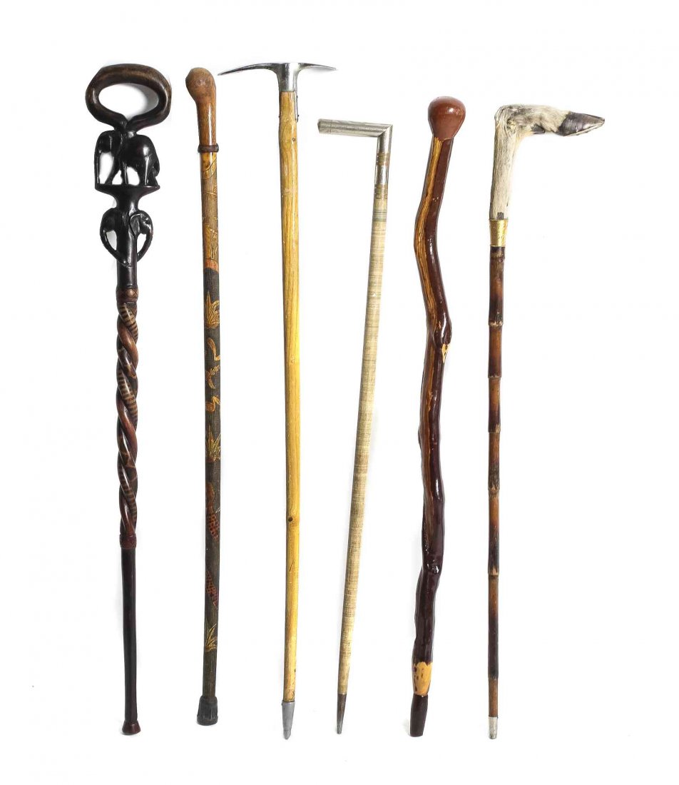 A Collection of Six Walking Sticks, Length of longest: A Collection of Six Walking Sticks, one with animal hoof handle metal band under handle inscribed John T Bottom from 236 Dec. 7 1902, one of twisted wood, one with carved elephant motif, and three oth