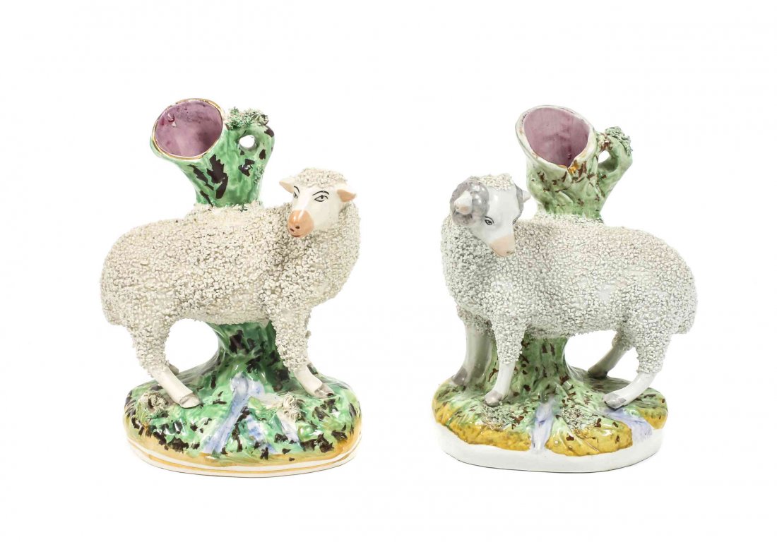 A Pair of Staffordshire Earthenware Figural Spill: A Pair of Staffordshire Earthenware Figural Spill Vases, depicting a male and female sheep on a naturalistic base. Height 8 inches. Property from the Estate of Eugene B. Clark Jr., Amarillo, Texas