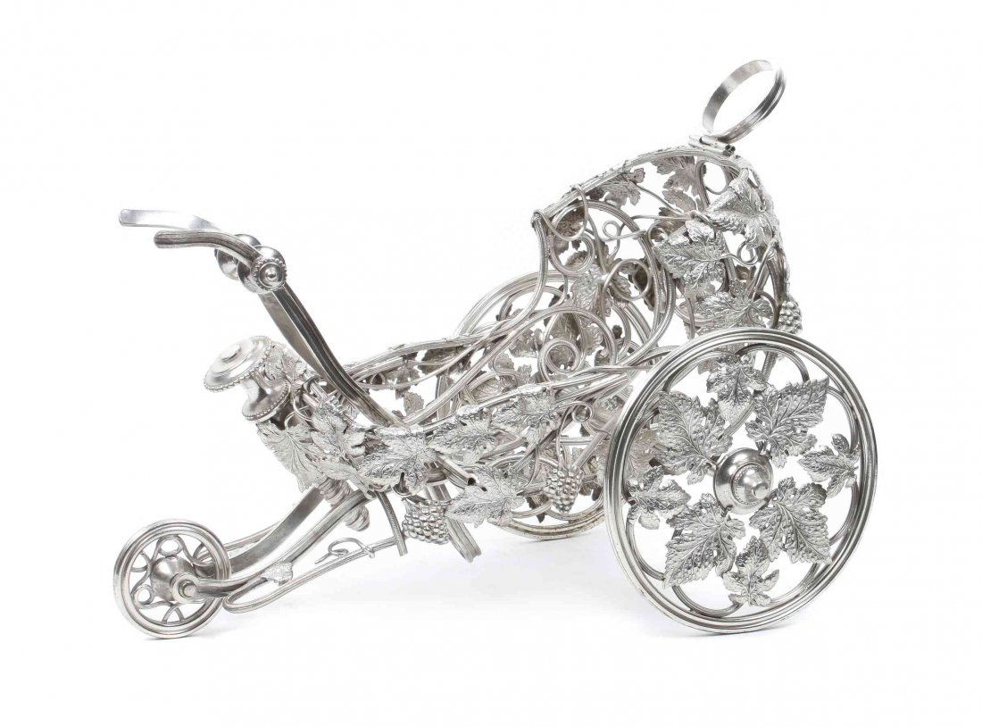 A French Silver-Plate Mechanical Wine Trolley,: A French Silver-Plate Mechanical Wine Trolley, Christofle, Paris, Circa 1870, of chariot from, worked throughout to show a grapevine motif. Length 12 inches.