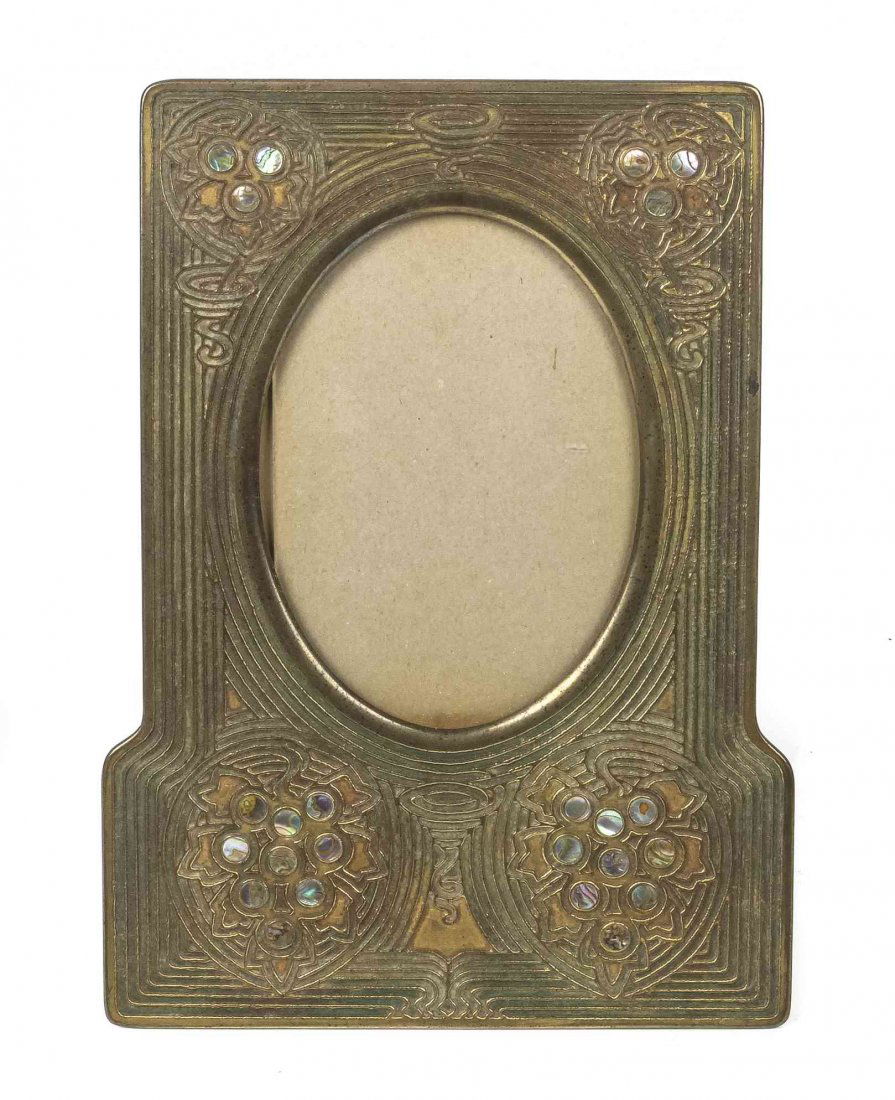 A Tiffany Studios Dore and Abalone Picture Frame,: A Tiffany Studios Dore and Abalone Picture Frame, in the Abalone pattern, having an oval frame, stamped Tiffany Studios New York and numbered 1171. Height 10 1/4 x width 7 1/2 inches. Property from th