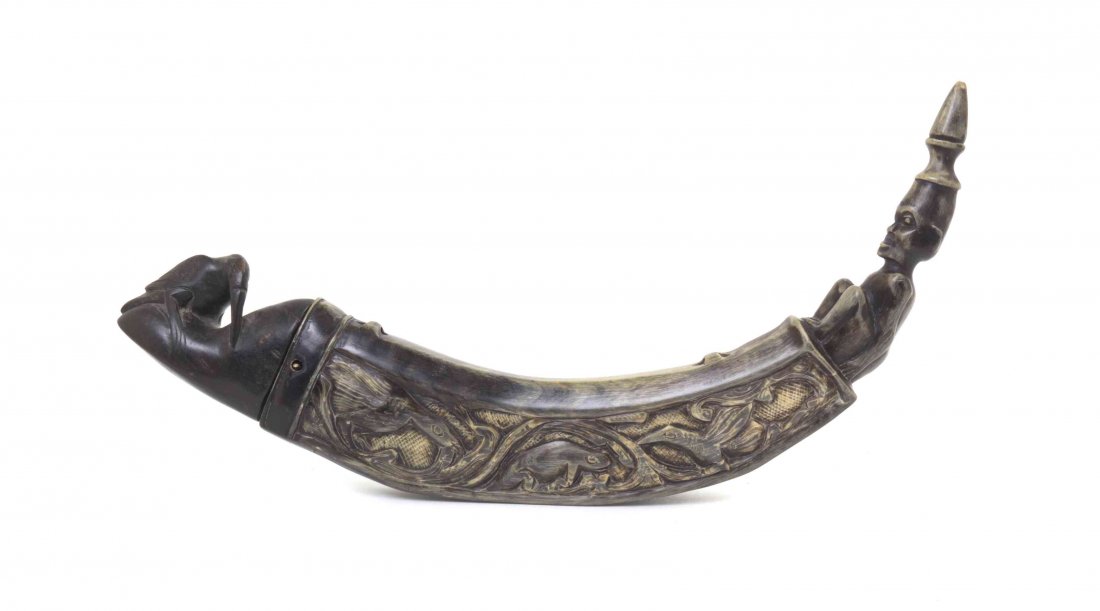 An African Carved Horn and Ebonized Wood Powder Horn,: An African Carved Horn and Ebonized Wood Powder Horn, having carved figural and bird decoration. Length 13 1/2 inches.