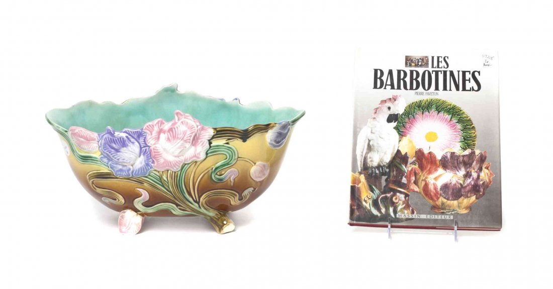 A French Faience Bowl, Width of first 14 3/4 inches.: A French Faience Bowl, of oval form with Art Nouveau floral decoration, together with a book on French faience works. Width of first 14 3/4 inches. Property from the Estate of Mary Flanagan, Chicago,