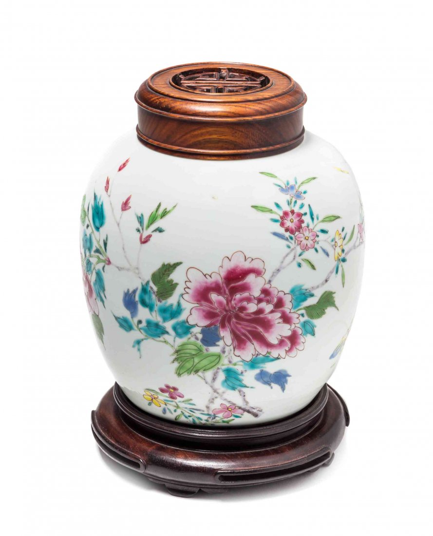A Famille Rose Ginger Jar, Height 7 1/4 inches.: A Famille Rose Ginger Jar, of ovoid form depicting flowering peonies, with a pierce carved wood cover and a wood base. Height 7 1/4 inches.