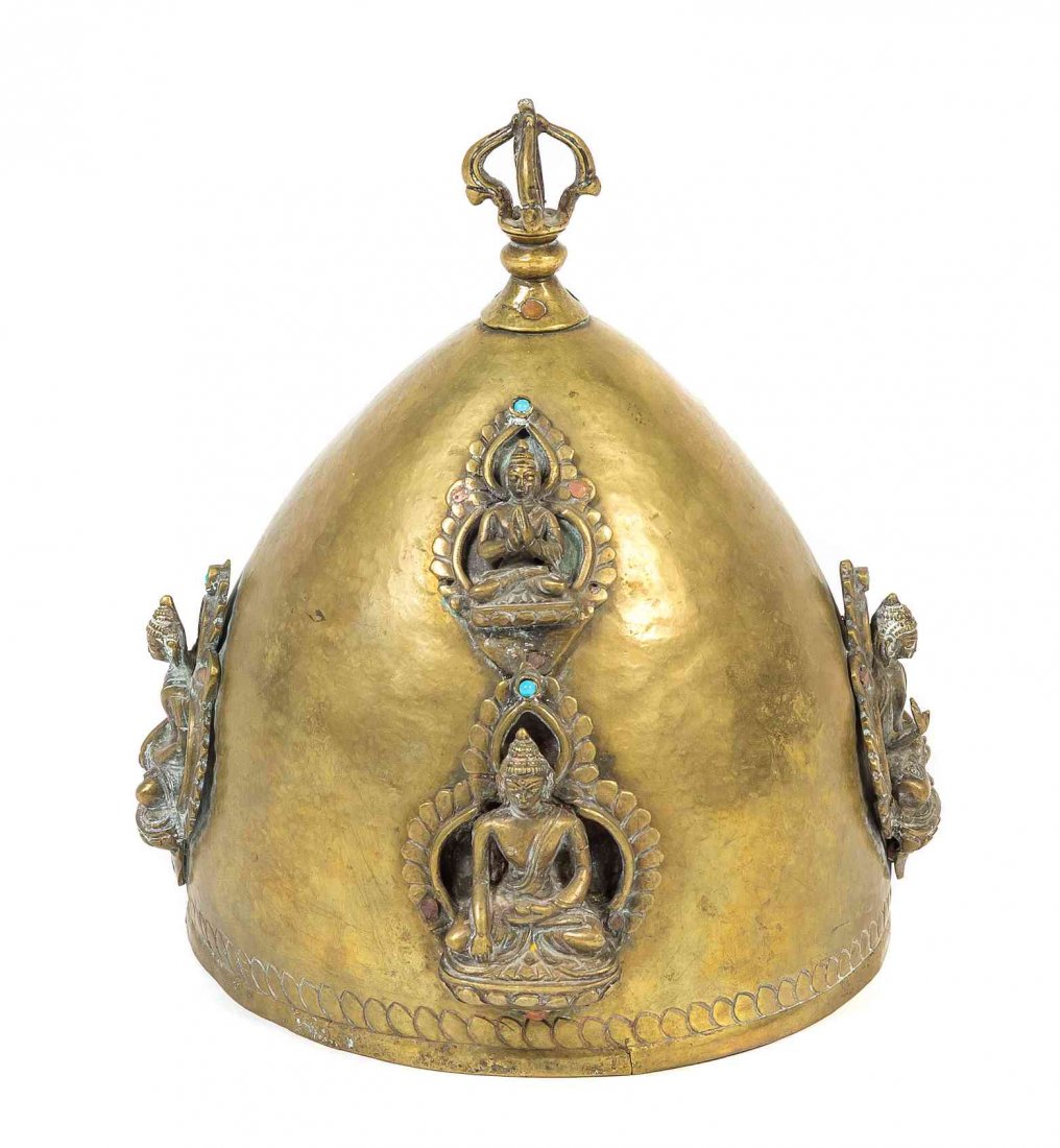 A Tibetan Gilt Bronze and Brass Ceremonial Helmet,: A Tibetan Gilt Bronze and Brass Ceremonial Helmet, of domed form, the cap made of hammered brass, with applied bronze Buddha figures, surmounted with a vajra finial. Height 10 inches. Condition: In ov