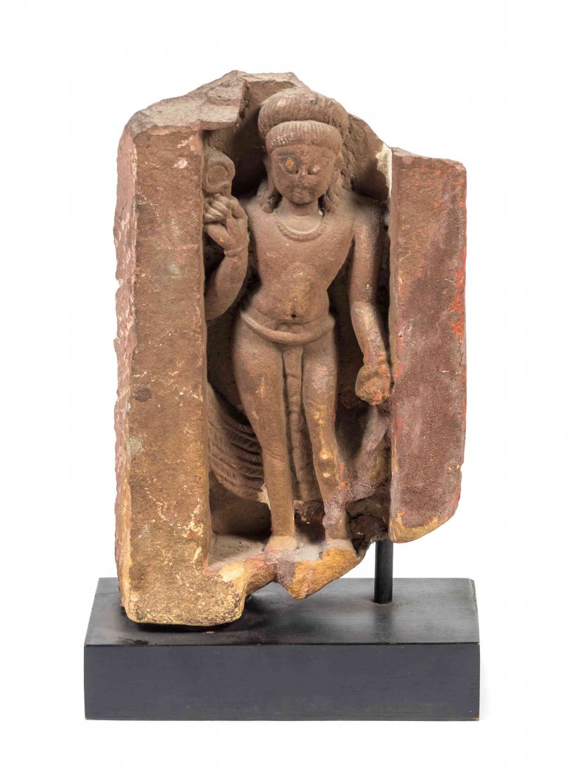 An Indian Stone Carving of Kartikeya Skanda, Height 16: An Indian Stone Carving of Kartikeya Skanda, likely Rajastani, the deity depicted standing and forward facing, one hand lowered to feed the peacock, the other likely holding a mace, raised on a later 