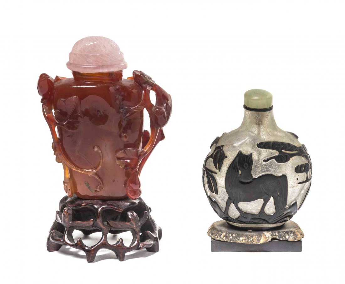 A Carved Carnelian Snuff Bottle, Height of first 2 3/4: A Carved Carnelian Snuff Bottle, depicting birds perched on scrolling branches of flowering prunus and leaves, having a rose quartz cover and raised on a fitted naturalistic wood base, together with a