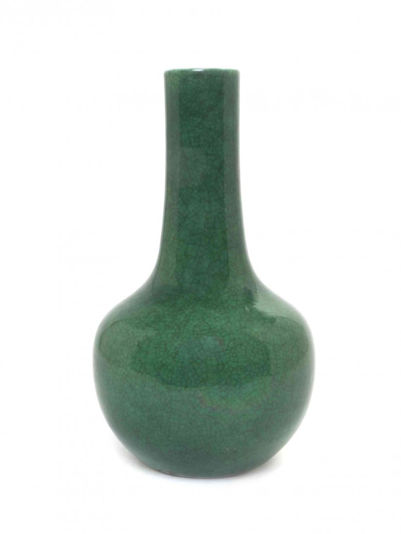A Green Crackle Glaze Bottle Vase, Height 8 1/2 inches.: A Green Crackle Glaze Bottle Vase, the cylindrical neck above gently sloping shoulders and a rounded tapering body, unmarked. Height 8 1/2 inches.