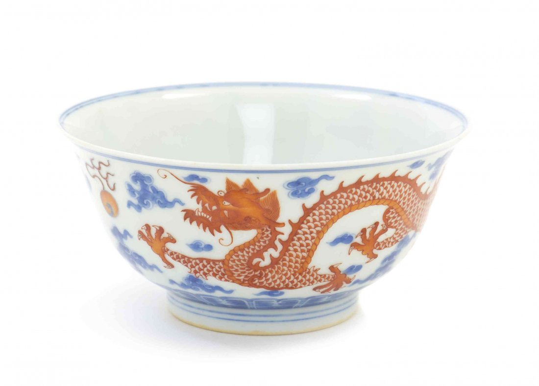 A Chinese Porcelain Bowl, Diameter 4 5/8 inches.: A Chinese Porcelain Bowl, having underglaze blue and red decoration, depicting writhing dragons above a lappet band, bearing Yongzheng mark to the underside. Diameter 4 5/8 inches.