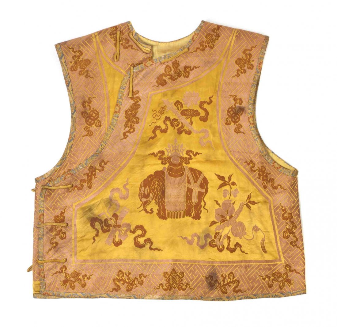 A Chinese Embroidered Man's Silk Vest, Height 23 1/8: A Chinese Embroidered Man's Silk Vest, the front and back embroidered with an elephant bearing a yinyang on its saddle, surrounded with Buddhist emblems on a mustard yellow silk ground, with peach col