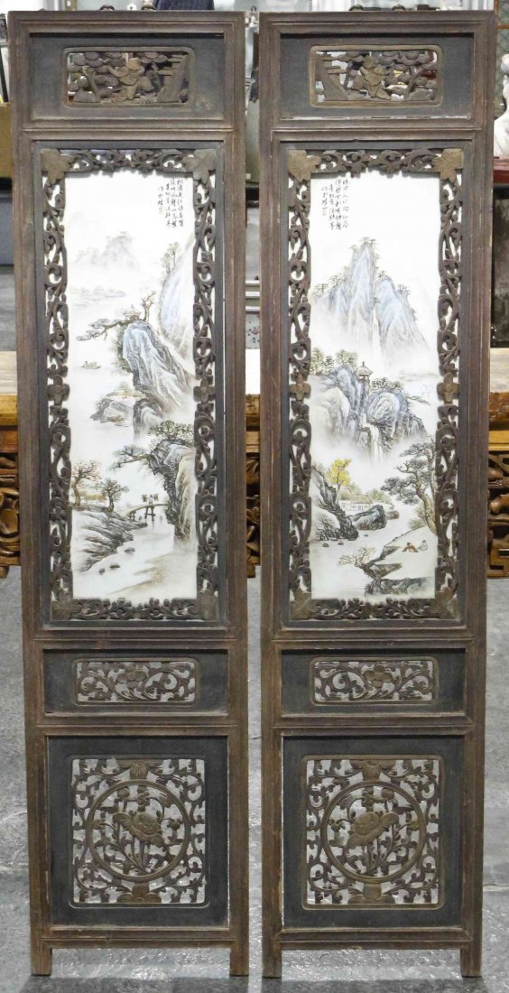 A Pair of Chinese Porcelain and Wood Screen Panels,: A Pair of Chinese Porcelain and Wood Screen Panels, each rectangular panel having foliate pierce carved panels and a porcelain plaque depicting mountainous landscapes. Height overall 55 inches. Condit