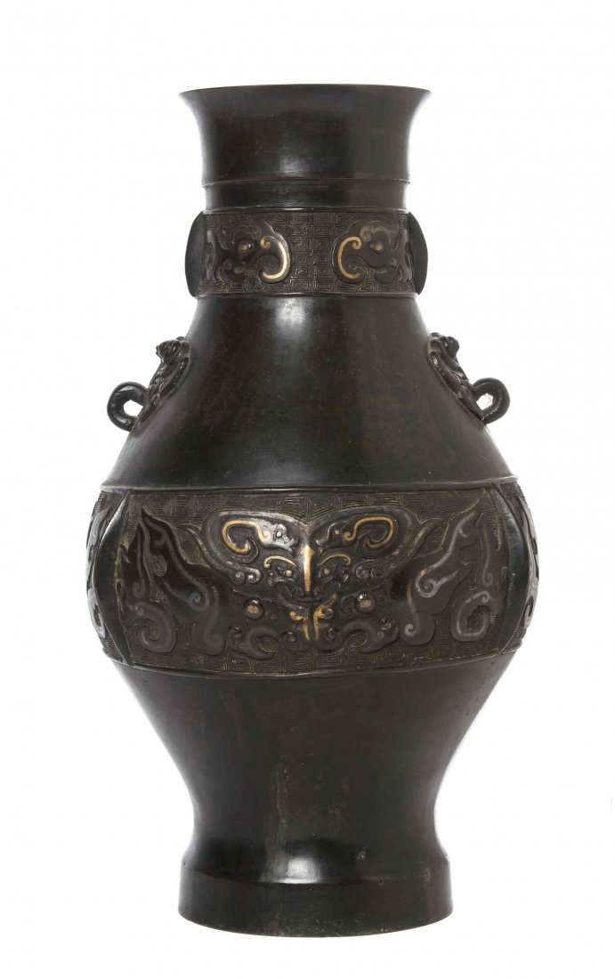 A Chinese Bronze Archaistic Vase, Height 14 1/2 inches.: A Chinese Bronze Archaistic Vase, with loop handles above the shoulder, with archaistic taotie decoration and raised on a flared foot. Height 14 1/2 inches.