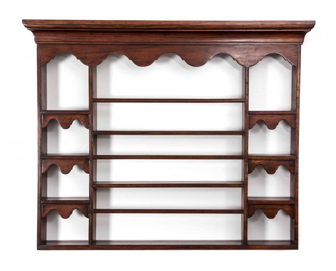 A French Provincial Hanging Plate Shelf, Height 42 x: A French Provincial Hanging Plate Shelf, having a molded cornice over the shaped skirt, with three shelves, flanked by two banks of four shelves. Height 42 x width 48 x depth 5 inches.