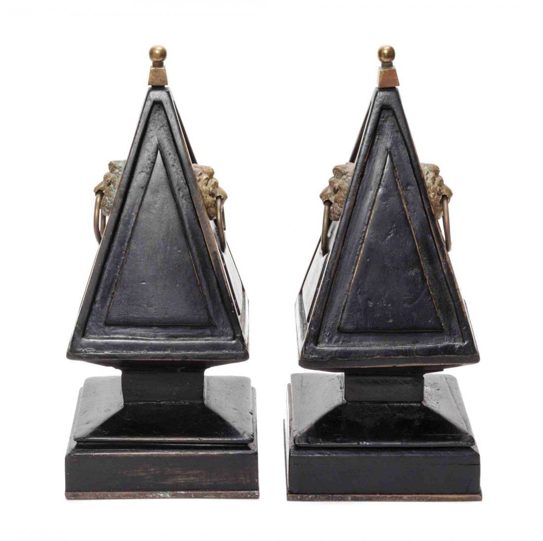 A Pair of English Carved and Ebonized Brass Mounted: A Pair of English Carved and Ebonized Brass Mounted Obelisks, each with lion's head drop rings and ball finial. Height 14 inches.