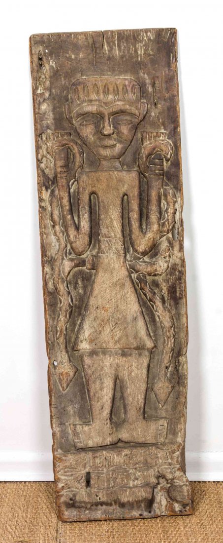 A Tanvanese Wood Carved Panel, Height 56 x width 16 1/2: A Tanvanese Wood Carved Panel, depicting a snake charmer. Height 56 x width 16 1/2 inches.