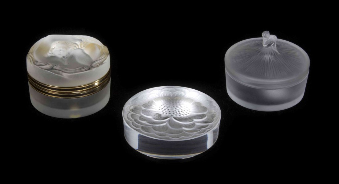 Three Lalique Molded and Frosted Glass Desk or Vanity: Three Lalique Molded and Frosted Glass Desk or Vanity Articles, in various patterns, comprising two powder boxes and a paperweight, each of circular form with various signatures. Diameter of largest 3