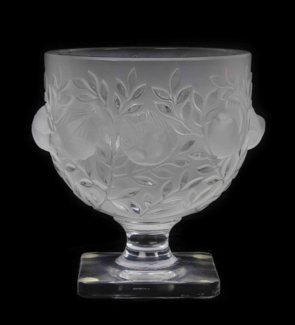 A Lalique Molded and Frosted Glass Compote, Height 5: A Lalique Molded and Frosted Glass Compote, Elisabeth, with a continuous band of birds amongst leafy branches, raised on a square foot, etched Lalique France. Height 5 3/8 inches. Condition: In overal