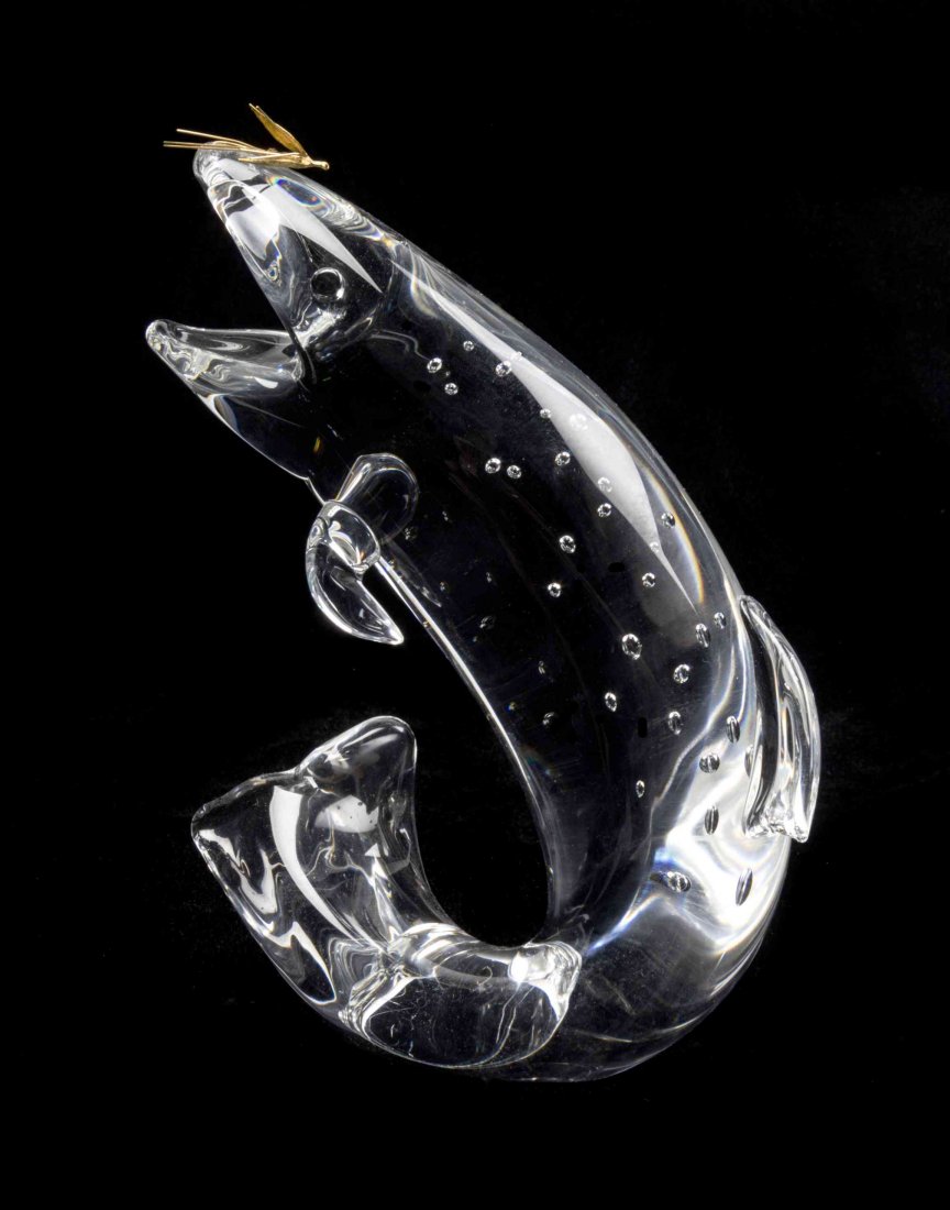 A Steuben Glass and 18 Karat Yellow Gold Sculpture,: A Steuben Glass and 18 Karat Yellow Gold Sculpture, Trout with Fly, designed by James Houston, introduced in 1966, model 1002, depicting a leaping fish. Height 9 inches. Condition: In overall good, co