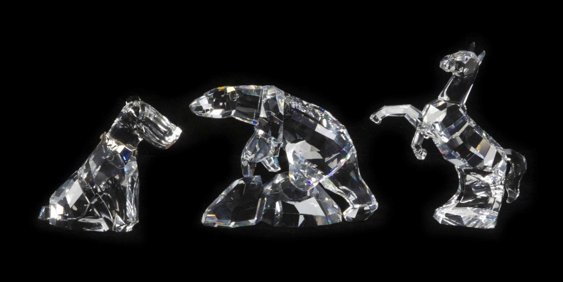 Three Swarovski Cut Glass Figures, Height of first 6: Three Swarovski Cut Glass Figures, depicting a rearing horse, a polar bear and a terrier, each with a Swarovski acid stamp and a fitted box. Height of first 6 1/4 inches. Property from the Frank Plevo