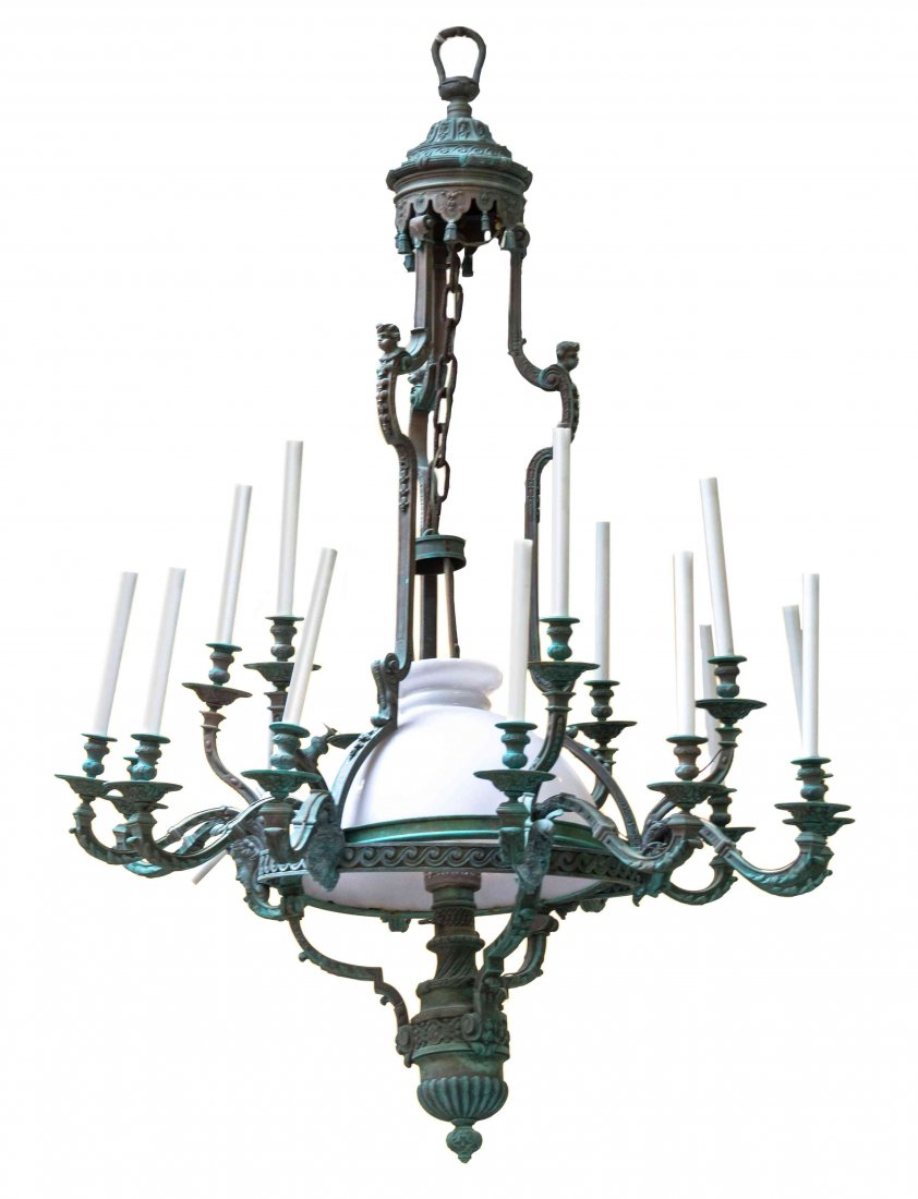 A Neoclassical Style Patinated Bronze Nineteen-Light: A Neoclassical Style Patinated Bronze Nineteen-Light Chandelier, the central lighting element and frosted glass shade within a circle having six masks issuing the candle arms in groups of three, with 