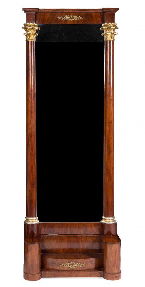 A French Empire Gilt Metal Mounted Mahogany Pier: A French Empire Gilt Metal Mounted Mahogany Pier Mirror, 19TH CENTURY, having a rectangular mirror plate flanked by columnar supports and raised on a shaped base. Height 91 1/2 x width 33 x depth 12 i