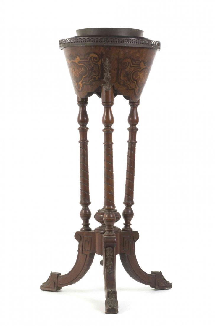 A Napoleon III Style Walnut Jardiniere on Stand, Height: A Napoleon III Style Walnut Jardiniere on Stand, having a circular galleried top with lift-out tole liner, raised on spiral twist carved supports and a tripod base with outsplayed legs, ending in styl