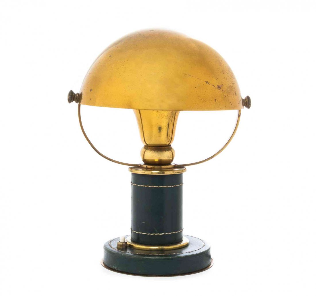 An Hermes Brass and Leather Desk Lamp, Height 10 1/2: An Hermes Brass and Leather Desk Lamp, CIRCA 1940s, THE DESIGN ATTRIBUTED TO PAUL DUPRE-LAFON, having a domed shade over a cylindrical stem on a circular base. Height 10 1/2 inches.