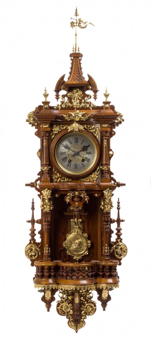 A German Gilt Metal Mounted Wall Clock, Height overall: A German Gilt Metal Mounted Wall Clock, LENZKIRCH, having an architectural form case surmounted with a horn-playing mermaid form finial over the circular dial, having Roman hours and Arabic minutes, w