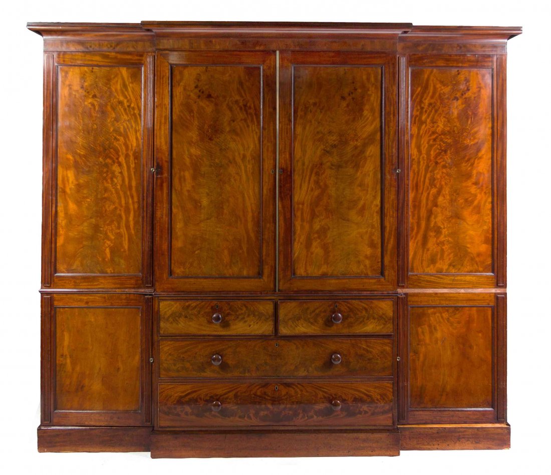 A George III Irish Mahogany Linen Press, LATE 18TH: An Irish George III Mahogany Linen Press, LATE 18TH CENTURY, WITH ALTERATION, in six parts, having a breakfront lift-off cornice over two paneled doors opening to an interior fitted for an entertainme