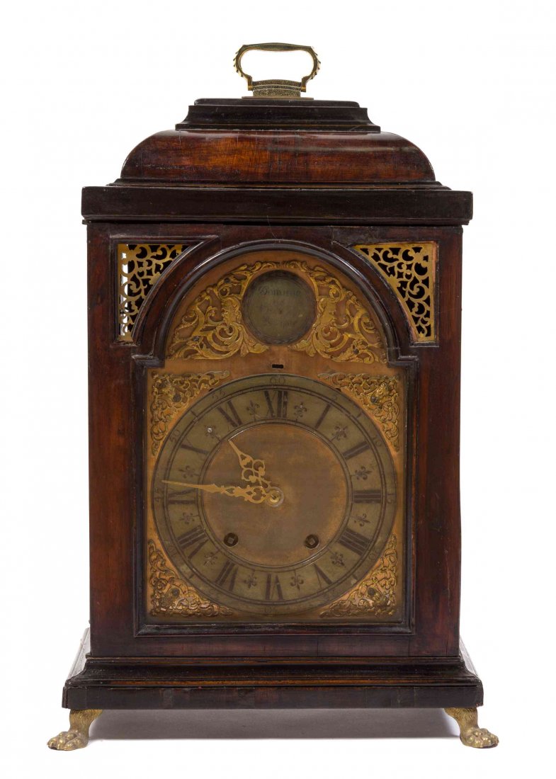 A Walnut Bracket Clock, DOMINIC ONOLYL, Height 19 1/4: A Walnut Bracket Clock, DOMINIC ONOLYL, having a domed handled cornice over the brass dial with Roman numerals, the whole raised on paw feet, having time and strike movement. Height 19 1/4 inches.