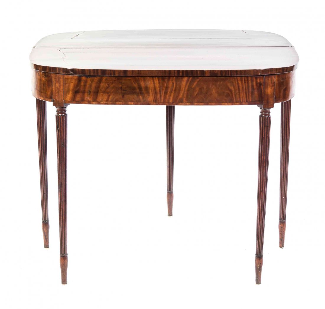 An American Mahogany Flip-Top Games Table, Height 29: An American Mahogany Flip-Top Games Table, having a D-shaped hinged lid above a plain frieze, raised on fluted tapering legs. Height 29 1/2 x width 35 3/8 x depth 17 1/2 inches (closed). Property from