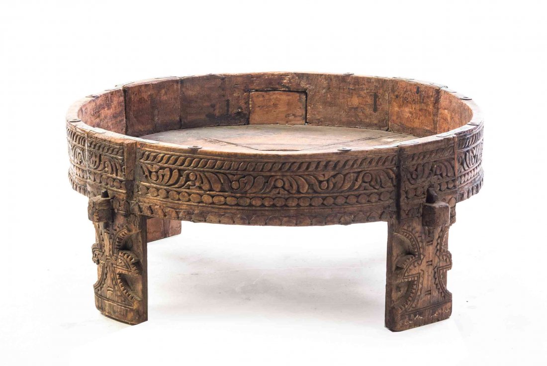A Carved Hardwood Drum Table, Height 12 1/4 x diameter: A Carved Hardwood Drum Table, having a circular top with a repeating geometric decorated frieze raised on four relief carved supports. Height 12 1/4 x diameter 29 inches. Property from the May Weber, 