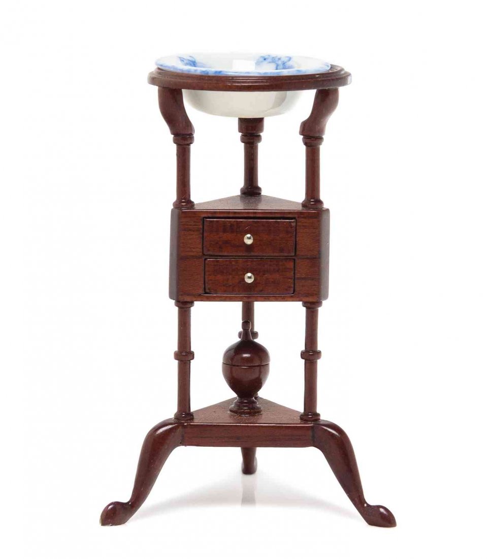 A George III Mahogany Washstand, Height 2 7/8 x: A George III Mahogany Washstand, RICHARD SIMMS, having a circular porcelain inset top raised on turned supports over two drawers and ring-turned supports ending in cabriole legs with pad feet. Height 
