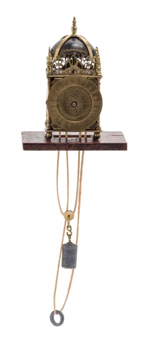 A Brass Lantern Clock, Height of clock 1 1/4 inches.: A Brass Lantern Clock, JIM WATT, with a rectangular wall bracket. Height of clock 1 1/4 inches. Property from the Collection of Cookie Ziemba, Lake Worth, Florida