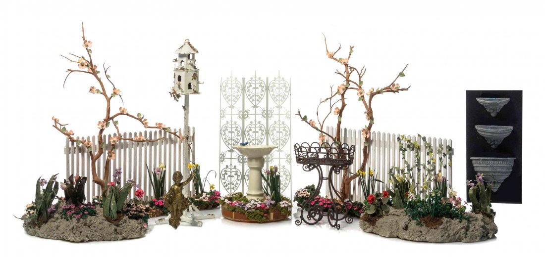 A Collection of Articles for a Garden, Height of bird: A Collection of Articles for a Garden, comprising two lengths of picket fence with flowering vines and trees, two groups of rockery overgrown with flowering plants, a bird house by Rosie Duck, a metal