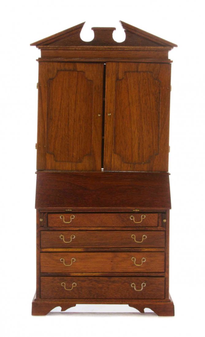An American Mahogany Secretary Bookcase, Height 7 x: An American Mahogany Secretary Bookcase, CHESTNUT HILL STUDIOS, in two parts, the upper section having a broken pediment cornice over two panelled cupboard doors, the lower section having a slant fron