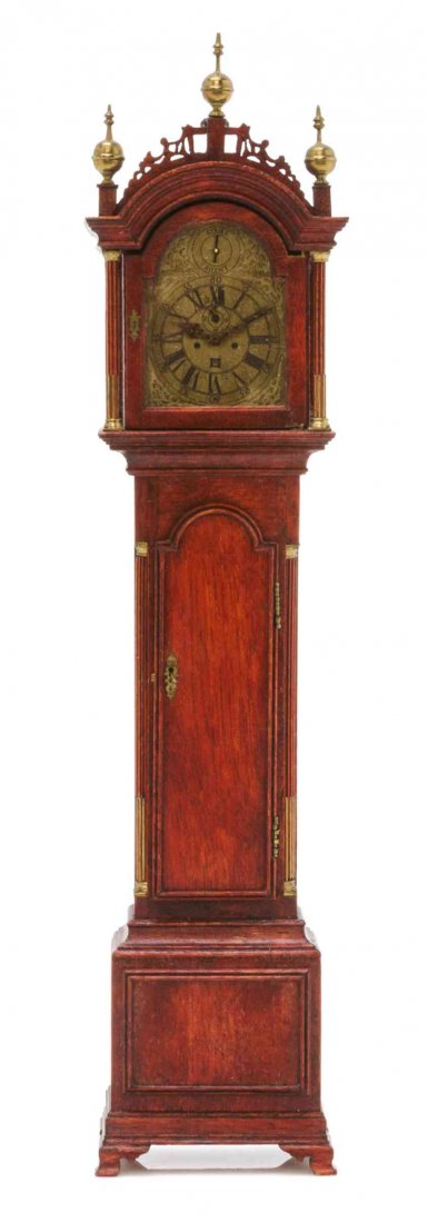 An American Tall Case Clock, Height 8 1/4 inches.: An American Tall Case Clock, RON TERRILL, 1979, having brass finials and a fretwork crest over the circular dial with Roman hours and Arabic minutes flanked by columns, the straight trunk with a domed