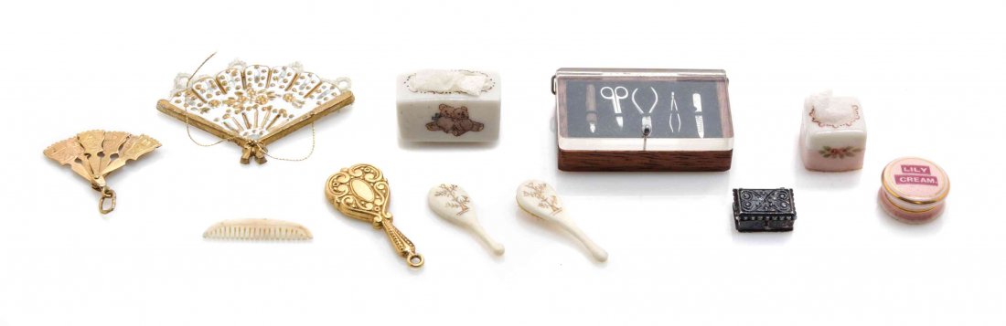 A Collection of Vanity Items, Width of first 1 1/2: A Collection of Vanity Items, comprising two fans, two tissue boxes, a metal jewel box, a cannister of "Lily Cream," a goldtone vanity mirror, a set of five nail tools in a case and a four piece vanit