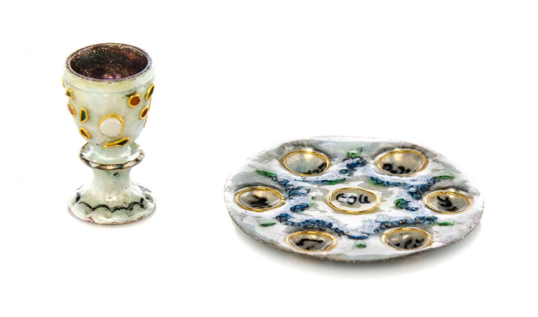 An Enameled Passover Seder Plate and Wine Cup, Diameter: An Enameled Passover Seder Plate and Wine Cup, LIGIA DURSTENFELD, each polychrome decorated. Diameter of plate 1 1/4 inches. Property from the Collection of Cookie Ziemba, Lake Worth, Florida