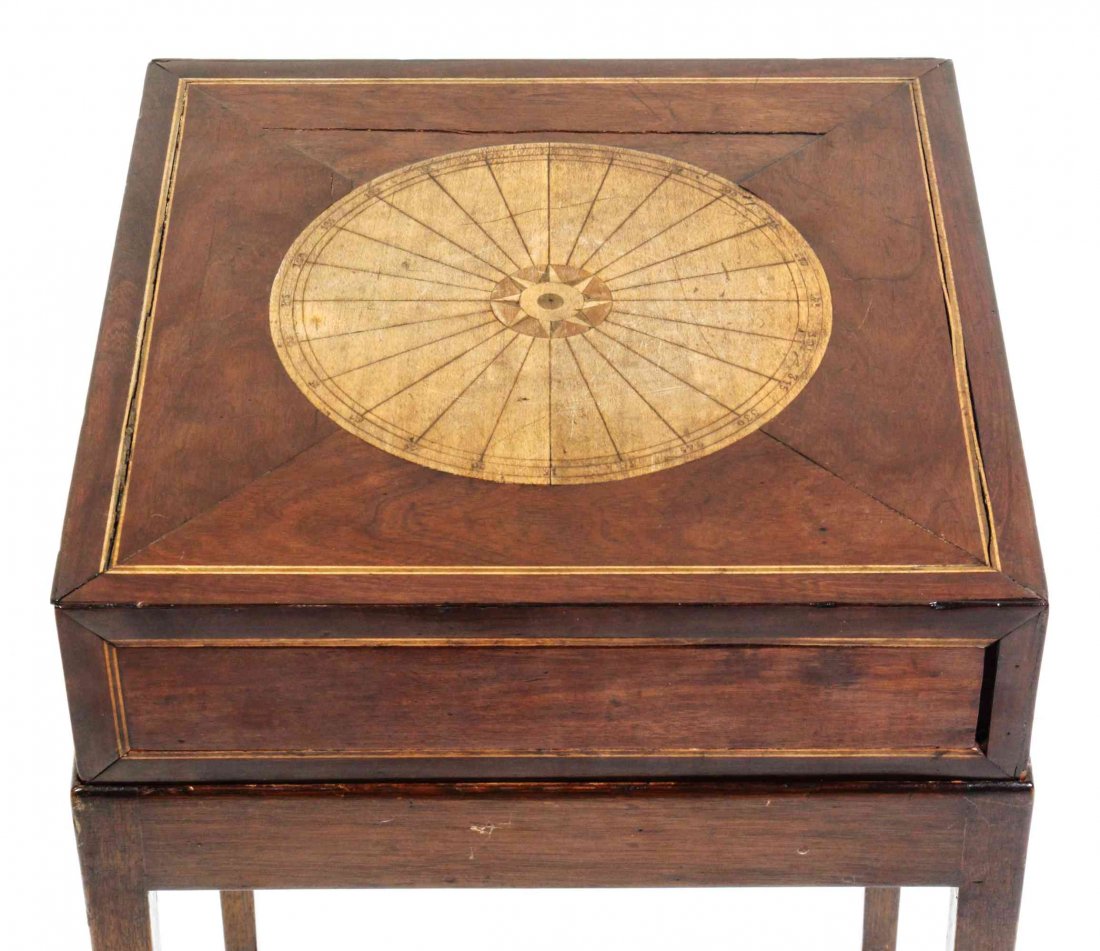 A George III Mahogany Puzzle Box, Height 28 x width 13: A George III Mahogany Puzzle Box, first quarter 19th century, having a rectangular top with circular inlay, the side with a sliding cover, raised on a conforming stand with square tapering legs. Heigh