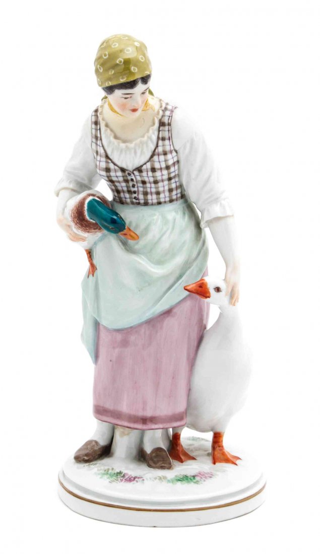 A Meissen Porcelain Figural Group, Height 9 3/4 inches.: A Meissen Porcelain Figural Group, LIKELY 20TH CENTURY, depicting a woman with a duck and a swan on a circular base, bearing a blue crossed swords mark to the underside. Height 9 3/4 inches.