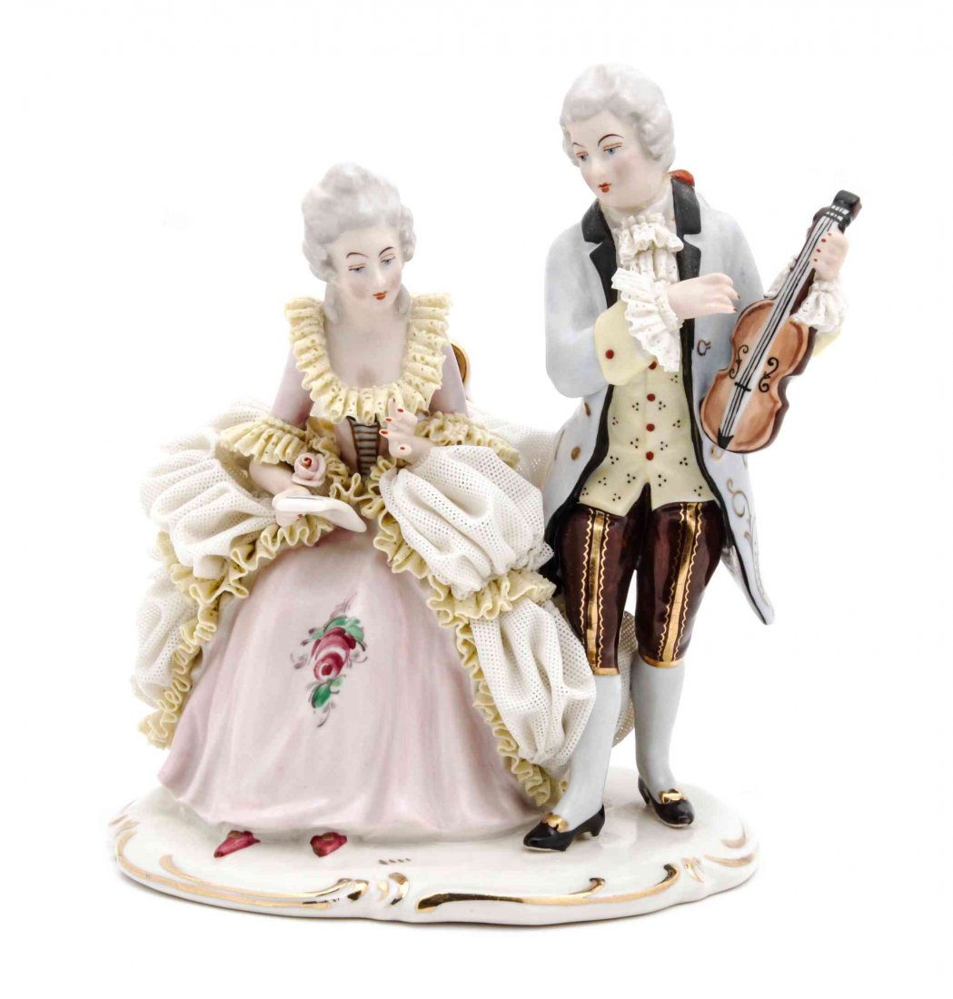 A Dresden Porcelain Figural Group, Height 7 1/2 inches.: A Dresden Porcelain Figural Group, LIKELY 20TH CENTURY, depicting a seated lady and a gentleman holding a violin, bearing a blue crossed swords mark to the underside. Height 7 1/2 inches.